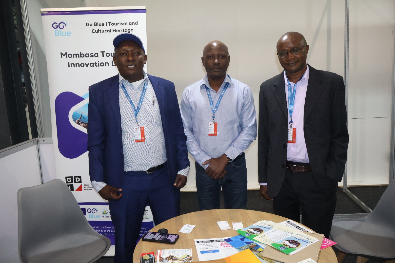 The participants posing for a picture on their exhibition booth during the event